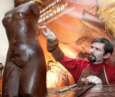 Sculptor makes the finish touches on a chocolate trunk