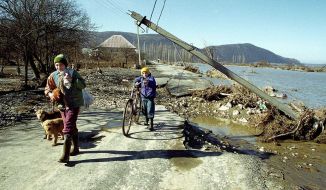 Children walk along the river Tisa 