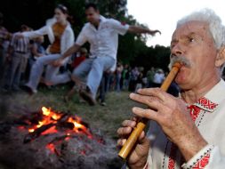 Young couple jump over fire