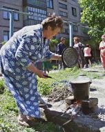 A woman prepares food in her yard