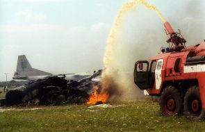 Firefighters extinguish a fire of the Su-27 jet wreckage