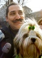 Vitaly Kononov holds a dog 