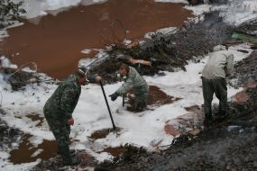 Emergency employeers collect the yellow phosphorus
