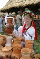 The girl sells clay pots