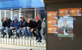 Boys sit on а fence in Burshtyn
