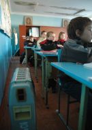 Pupils at the lesson at school without heating