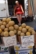 A woman sells melons