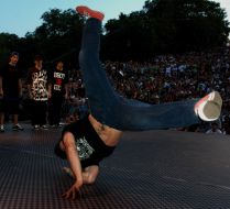 A fellow dances breakdance
