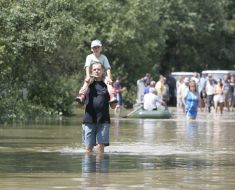 Люди идут по затопленной улице