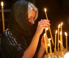 Church member set wax light at divine service