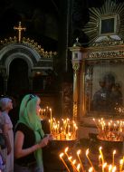 Church member set wax light at divine service