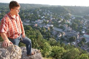 A tourist stands on ruins of walls of ancient fortress