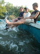 Діти сидять на березі басейну