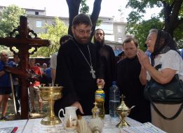 Priest standing near a cross