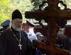 Priest standing near a cross