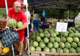 A buyer takes away water-melons