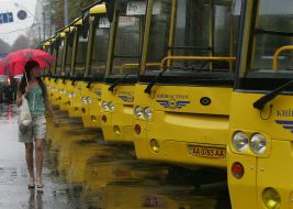 A girl passes near new busses