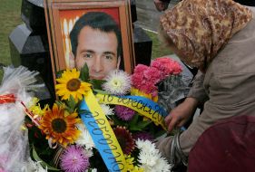 A woman lays flowers