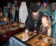 Priest wipes an icon