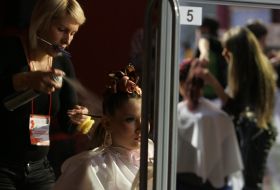 A hairdresser makes a hairdo