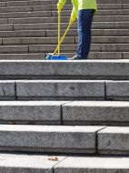 The habitant of city sweeps the Potyomkin`s stairs