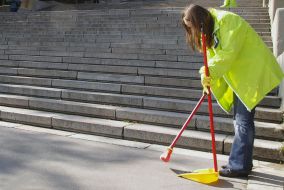 The habitant of city sweeps the Potyomkin`s stairs