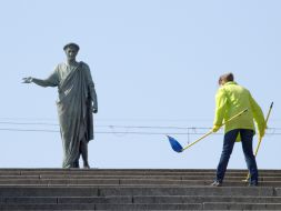 The habitant of city sweeps the Potyomkin`s stairs
