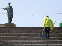 The habitant of city sweeps the Potyomkin`s stairs