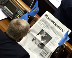 A deputy reads a newspaper