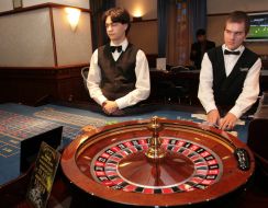 A croupier stands near roulette