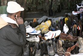 Merchant stands near the goods