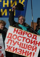 Protest action participants hold placards