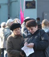 A woman checks up the picket participants lists for money payment