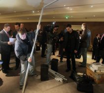 A worker takes apart a screen