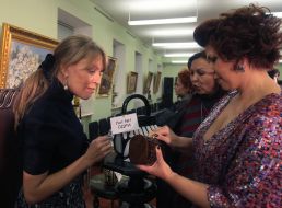 Charitable auction visitors examine lots