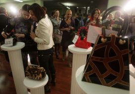 Charitable auction visitors examine lots