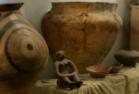 Clay tableware and woman’s figure