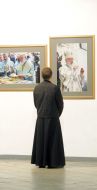 A priest examines photos