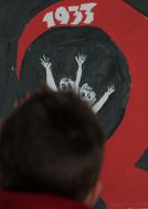 A visitor examines one of exhibition works