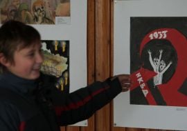 A boy examines pictures on the exhibition devoted to the memory of Golodomor victims