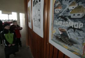 Children examine pictures on an exhibition