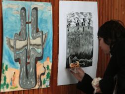 A visitor examines one of exhibition works