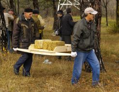 The participants of action carry bricks