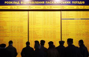 People examine board with the train schedule