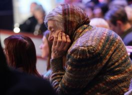 An elderly woman in a studio