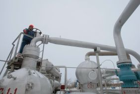A worker twirls a valve