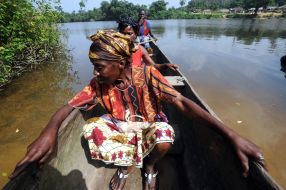 Local habitants swim on a boat
