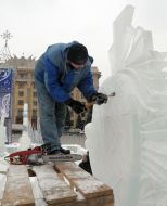 A sculptor works above creation of ice sculpture