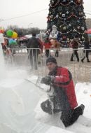 A sculptor works above creation of ice sculpture