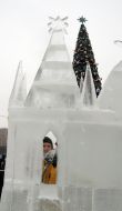 A sculptor works above creation of ice sculpture